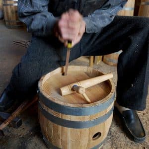 Cooper working on wooden barrel - how a wooden barrel is made - beer barrel, wine barrel, spirit barrel