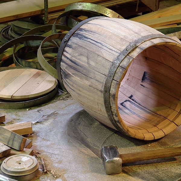 wooden oak barrel being assembled - making wood barrels - whiskey barrels, beer barrels, wine barrels, barrel aging beer